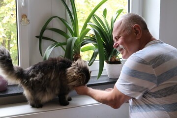 A cat and a man enjoying after a specialized PSA training in Georgia.