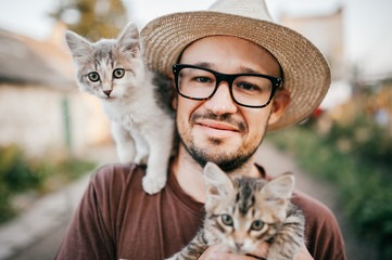A man with 2 cats on his shoulders after a specialized PSA training in Georgia.